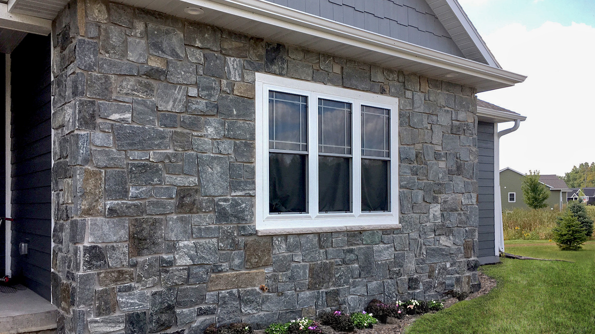 Stone veneer home exterior by Global Masonry